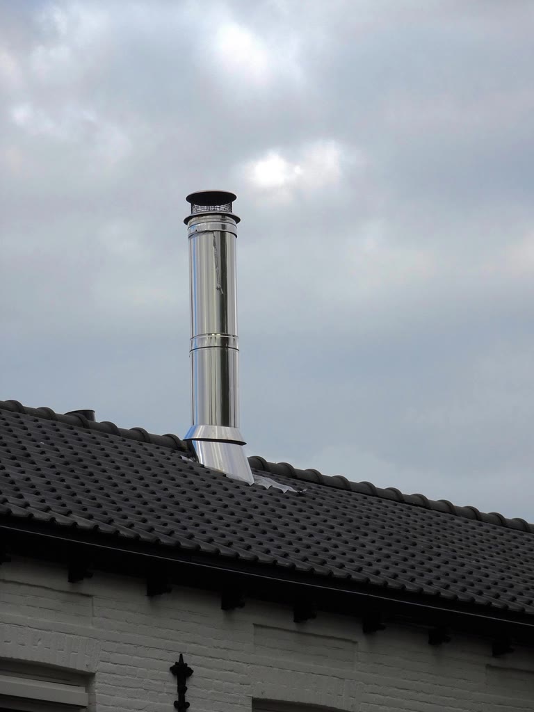 Stainless steel chimney liner and cap on a shingled roof